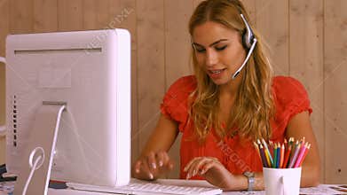 Pretty worker using video chat at desk