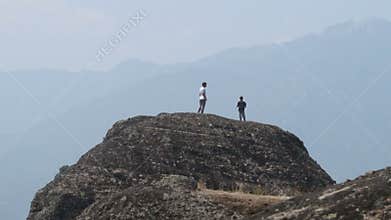 Tourists on the top of the Meteor in Greece