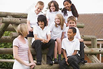 School children sitting on benches outside