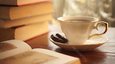 Fresh breakfast with hot coffee and reading book in morning sunlight