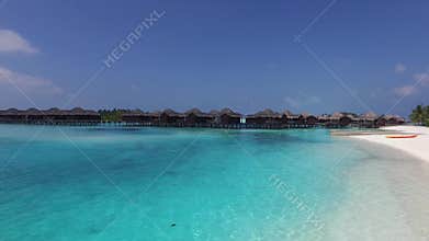 Bungalow huts in sea on tropical resort beach