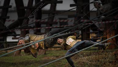 Competitors falling from ropes at 2014 Tough guy obstacle race