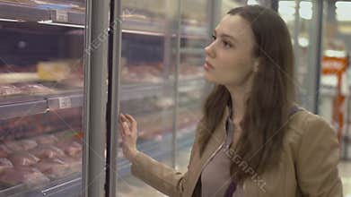 Sweet young woman walking on the supermarket