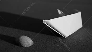 Paper boat and sea shell