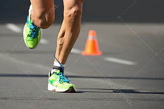 Running shoes, feet and legs close up of runner