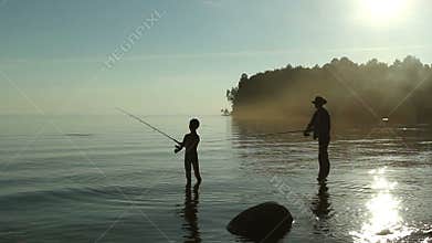 Father and son fishing on the lake.
