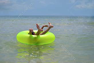 Boy in inflatable beach ring
