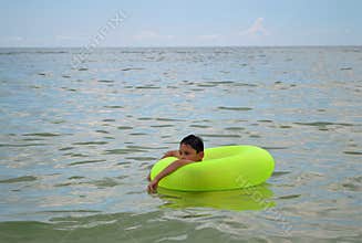 Boy floating in inflatable ring