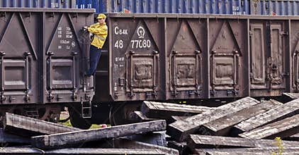 Railway worker working on freight wagon at Pukou Railway Station, Nanjing