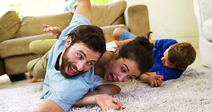 Happy family playing on the carpet together