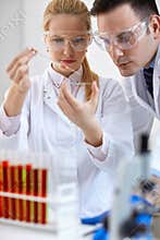 Two medical researcher doing microbiology experiment