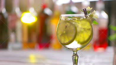 Glass of cocktail slowly rotates.