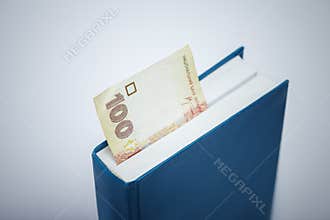 Ukrainian money bookmark in the book