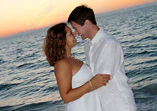 Couple on beach at sunset