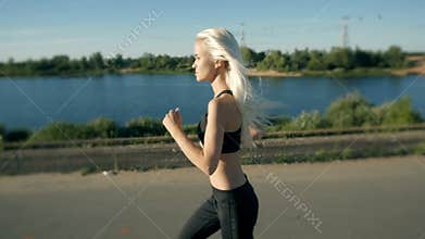 Athletic Woman Running near the Beach. Female Runner Jogging. Outdoor Workout.