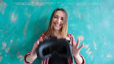 Young woman giving virtual reality headset