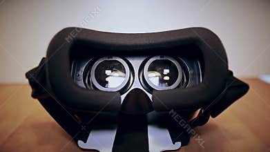 Camera moves slow around virtual reality glasses, vr, lying on the table, view from different sides