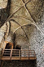 Stony walls interior of the castle with wooden bridge