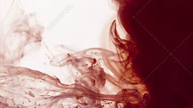 Red and purple smoke on a clear background creating volutes and swirls and filling the screen on right