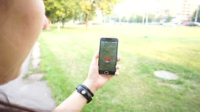 People playing Pokemon GO application the hit augmented reality smart phone app while trying to catch Pokemon Zubat.