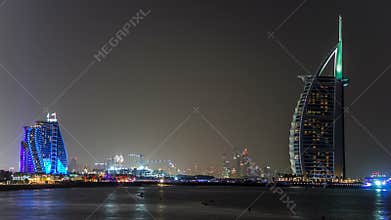 Dubai skyline with Burj Al Arab hotel at night timelapse.