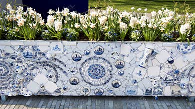 Flower container in artistic composition with dutch tiles