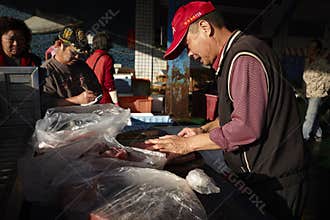 Chinese old man selling fish meat
