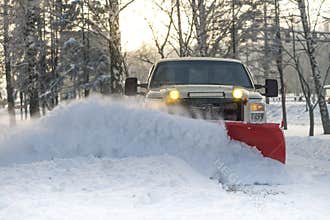 Snow plow doing snow removal after a blizzard