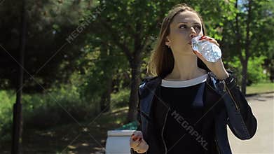 Young pretty girl drinking mineral water