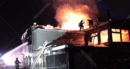 Huge fire blazing in commercial building.