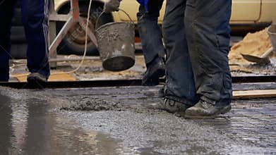 Pouring, Laying Concrete at the Construction Site using Buckets of Cement. Slow Motion