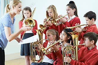 Group Of Students Playing In School Orchestra Together