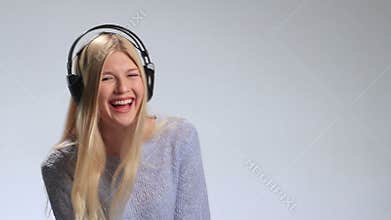 Emotional girl in headphones listening to music
