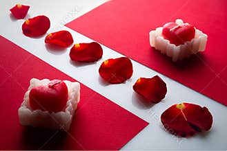 Heart candle on the red cartons, and rose petals in between