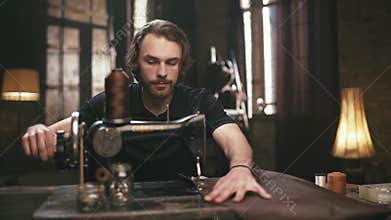 The young, bearded man, makes leather goods