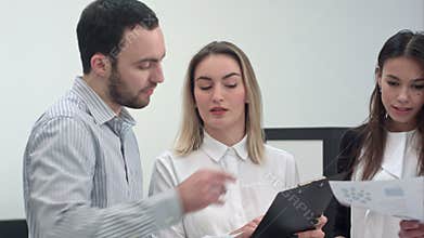 Young business people discussing market research with colleagues