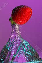 Strawberry falling in water