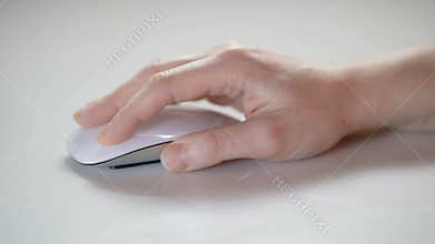 Woman hand using the mouse of a computer