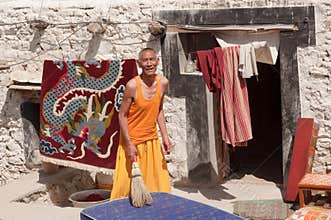Elderly man monk posing in traditional Tibetian dress in Ladakh, North India
