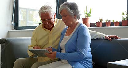 Senior couple using digital tablet