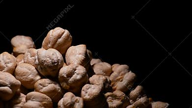 Chickpeas or garbanzos turning on black background