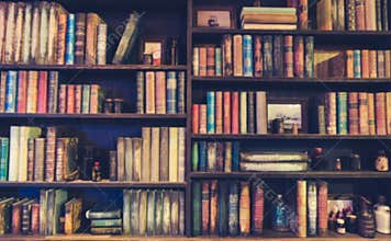 Blurred Image Many old books on bookshelf in library .
