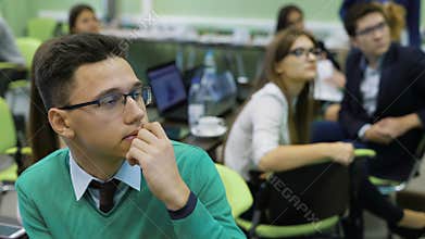 Students at the university. Young and promising students on practical training in the classroom. They carefully look at