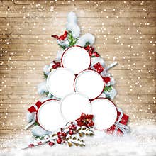 Christmas tree with frames for family photos on wooden background