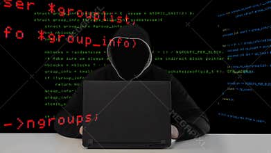 Hacker in black hood with a laptop