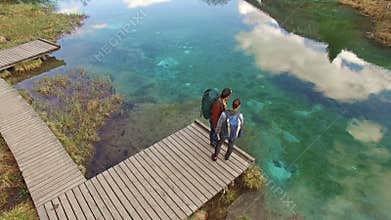 Women Backpackers Amaze At The Beautiful Lake