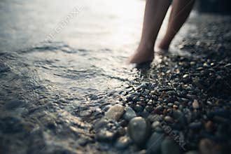 Bare feet in the sea water