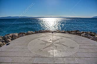 Compass by the sea