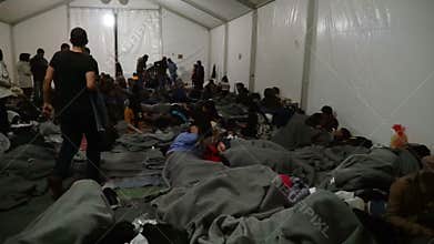LESVOS, GREECE - NOV 5, 2015: Refugees in a tent at a temporary camp.