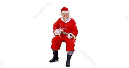 Santa claus singing a song and playing guitar